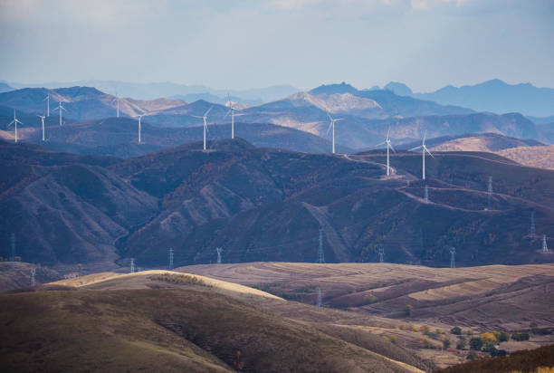 istock Rolling hills strung with wind turbines and high-voltage towers 1722313523