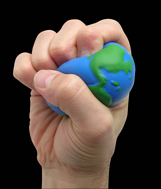 esmague o mundo - crushed human hand earth ball imagens e fotografias de stock