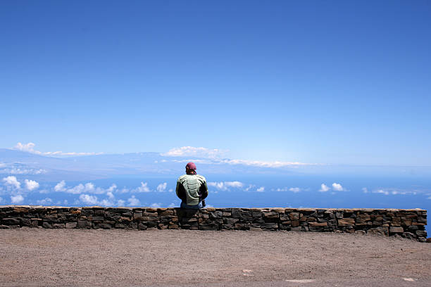 istock Man sitting on wall overlooking Haleakala Hawaii 172231662