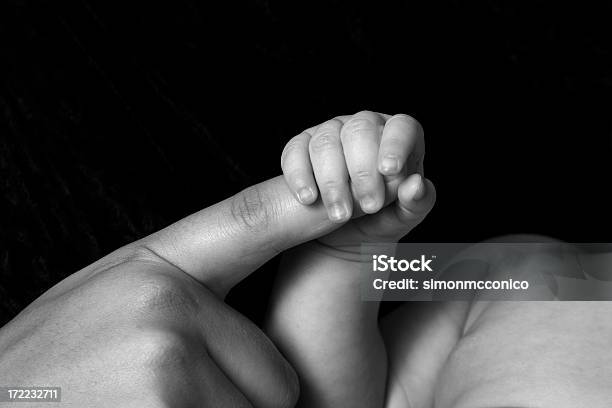 Black And White Of A Babys Hand Holding His Moms Finger Stock Photo - Download Image Now