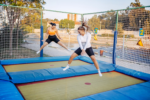 Young women jump on trampoline