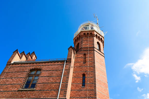 Ustka, Poland 28 August 2022 Baltic Sea lighthouse against blue sky