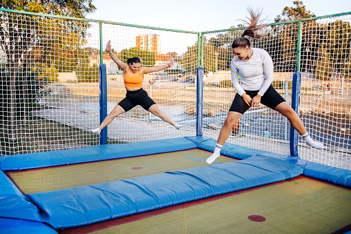 Young women jump on trampoline
