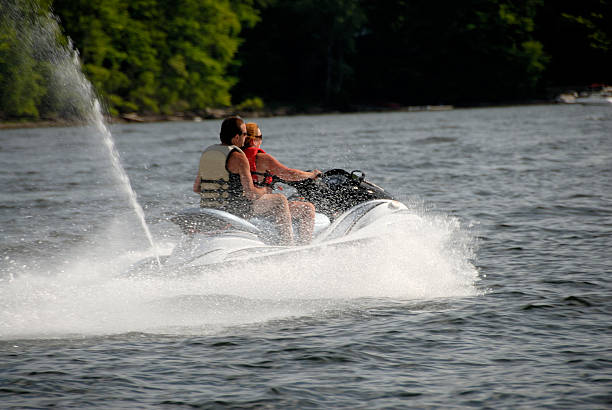 istock Couple Races Across A Lake On Jet Ski 172232817