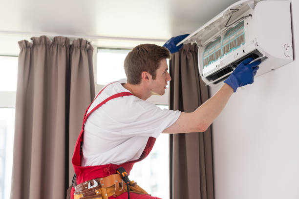 istock Professional technician maintaining modern air conditioner indoors. 1722332024
