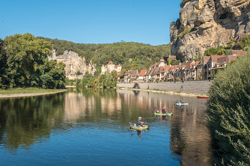 La Roque-Gageac, Nouvelle-Aquitaine, France - 30th September 2023: Three fisherman on the Dordogne river at La Roque-Gageac, one of the Plus Beaux Villages de France.