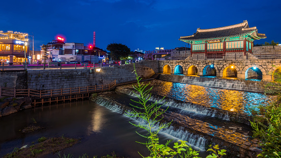 Suwon, South Korea: July 30, 2023: Hwahongmun Gate on Suwoncheon Creek at Suwon Hwaseong Fortress at night. This historical place is the Famous Unesco World Heritage in South Korea.
