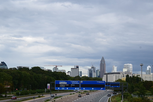Frankfurt, Germany - 09/23/2023: Autobahn into Frankfurt with gray clouds above the skyline