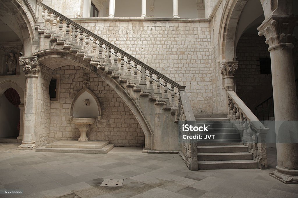 Stone staircase and courtyard. Stone stairs with Roman styling in a courtyard. Castle Stock Photo