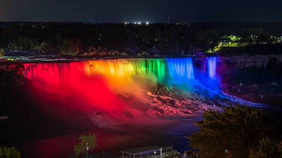 A stunning view of The American Falls lit up by the nightly light show, Niagara Falls, Canada
