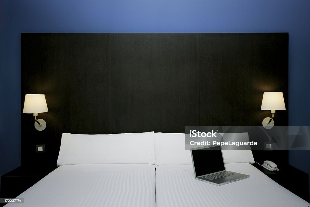 Hotel room Modern hotel room with a  laptop on the bed. Symmetry Stock Photo