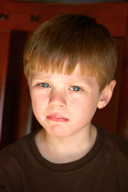 istock A young boy looking angrily at the camera 172237560