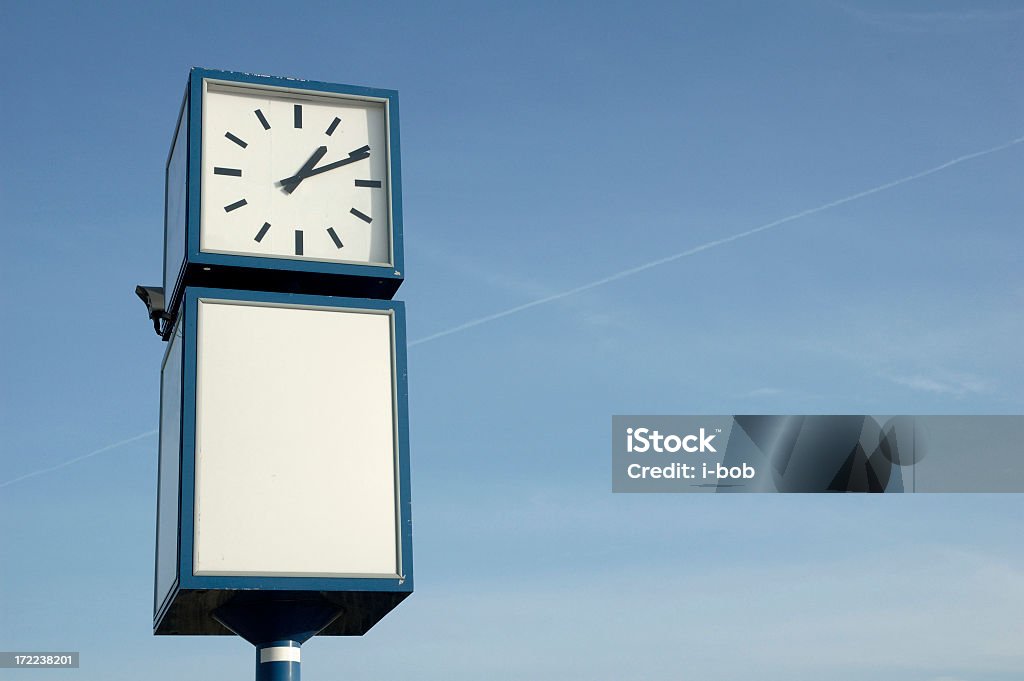public clock public clock in front of a blue sky 12 O'Clock Stock Photo