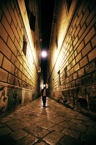african man walking in narrow street.