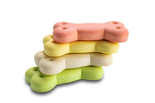 Stack of colorful bone shaped dog biscuit isolated on white background with clipping path.