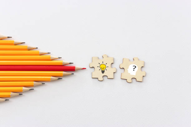 bright light bulb and question mark with pencils concept image