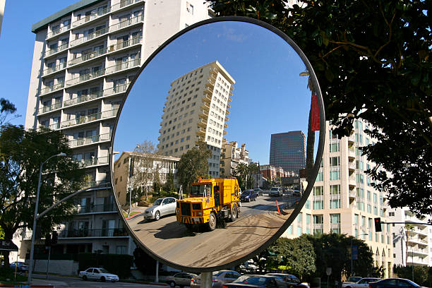 Highgate Hill, London, England - October 31th 2023:  Pullout mirror at a driveway leading out in a steep road over a hill