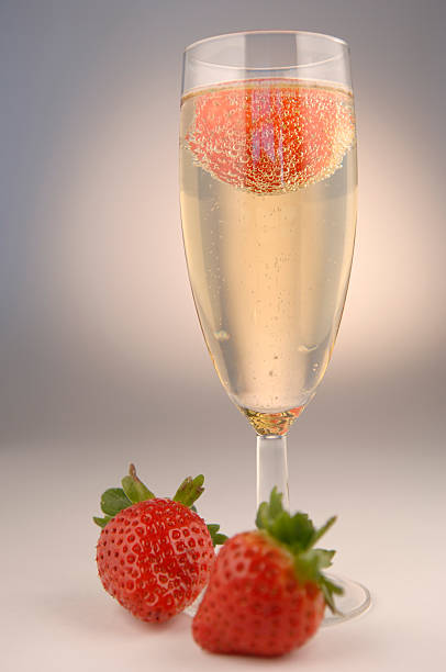istock Glass of champagne with strawberries on a white back ground. 172239111