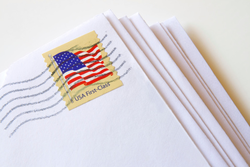 Stack of letters with USA First Class Stamp