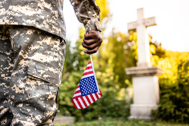 istock Soldier with American flag on Memorial Day. 1722399213