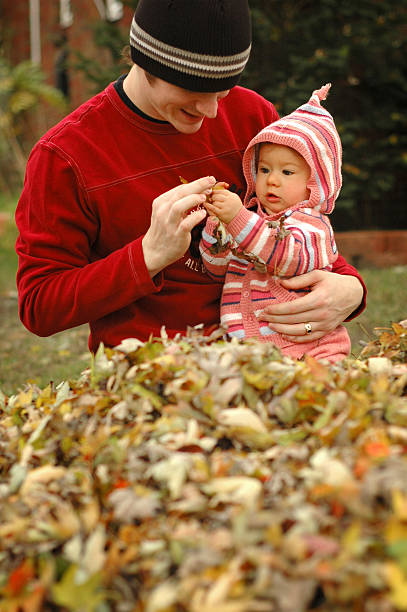 istock Father and Daughter Discovering Leaves in Autumn 172240114
