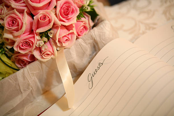red rose with guestbook A bunch of red rose with a guestbook. guest book photos stock pictures, royalty-free photos & images