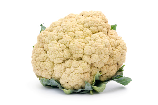 An organic cauliflower plant, a fresh, raw vegetable food, isolated on a white background.