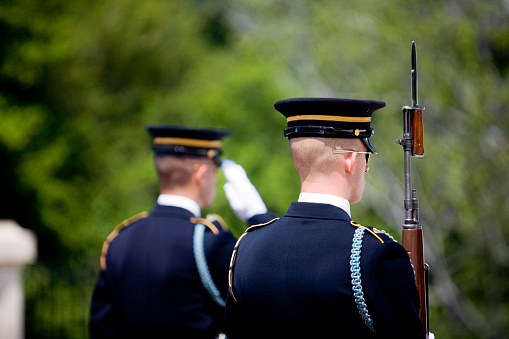 This is a close up horizontal, color photograph of a United States Navy officer's decorated dress uniform.