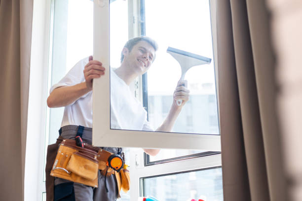 istock Young man washing window in office 1722409501