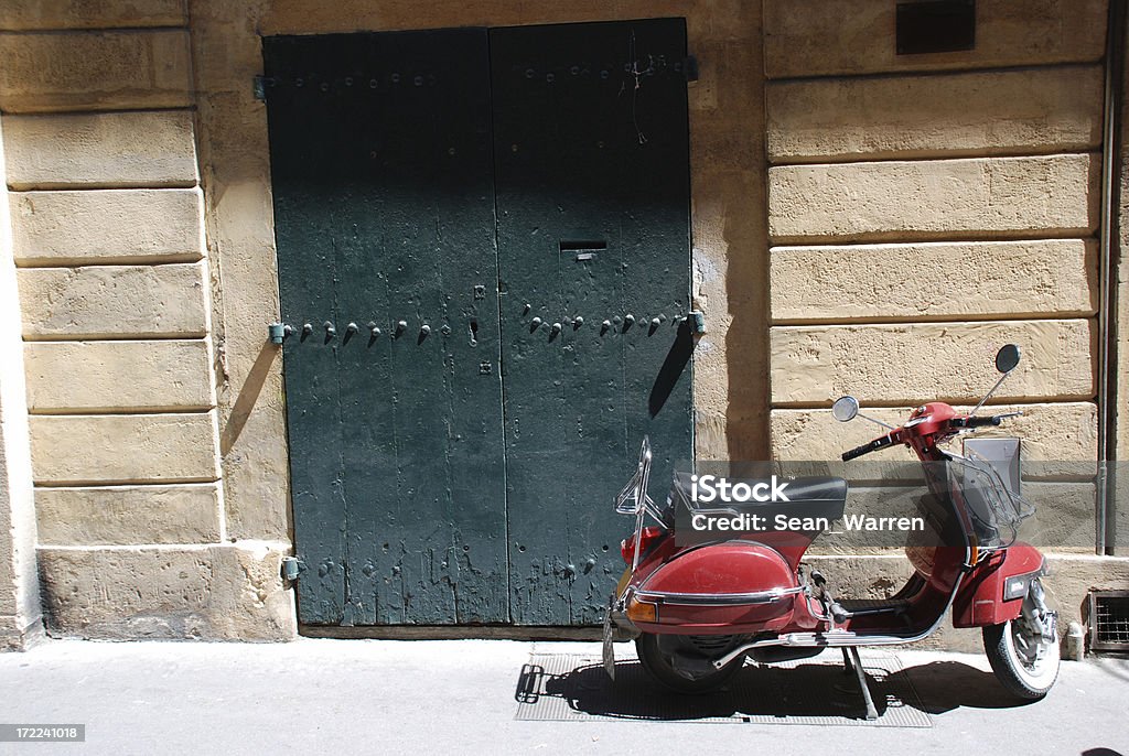 Scooter - Going Green By Driving Old Red "A red scooter sits outside an apartment in Aix-en-Provence, France." Copy Space Stock Photo