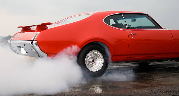 Burning Rubber! Oldmobile Cutlass Supreme getting ready to drag race.Other similar images.... car burnout stock pictures, royalty-free photos & images