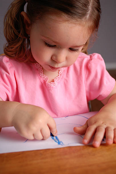 istock Little Girl Drawing while Sitting in School Desk 172241425