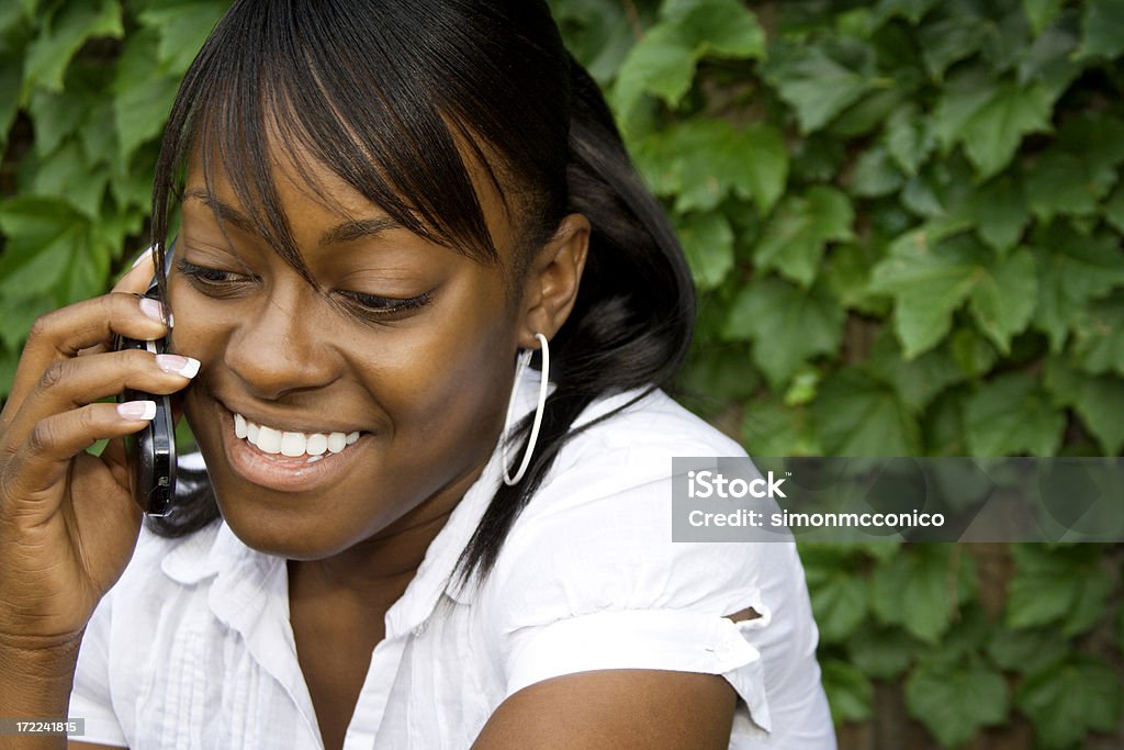 Modern Girl A modern girl on a cell phone Flip Phone Stock Photo