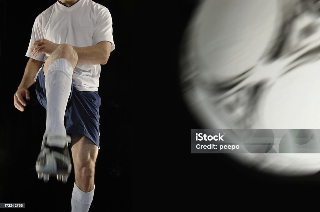 football player close crop image of football player in action against plain black background Activity Stock Photo