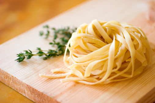 Fresh Tagliatelle pasta with herbs.  Shallow dof