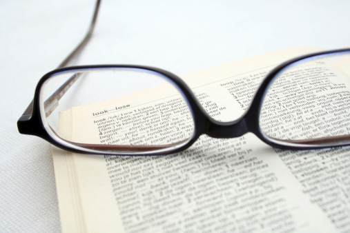 glasses on an opened book