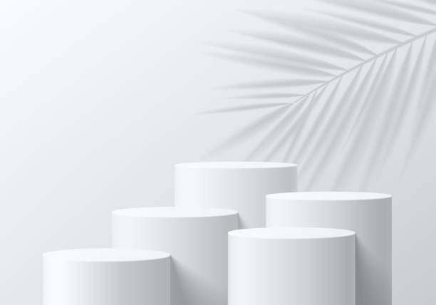 istock Set of abstract 3D white cylinder pedestal podium background with palm leaf shadow overlay. Mockup product display presentation. Minimal wall scene. Stage showcase. Platforms vector geometric design. 1722434143