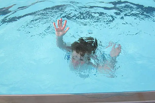 "Young boy, sinking into the water (no actual children hurt during the making of this photo)."