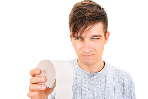 Sad Young Man with a Toilet Paper Isolated on the White Background