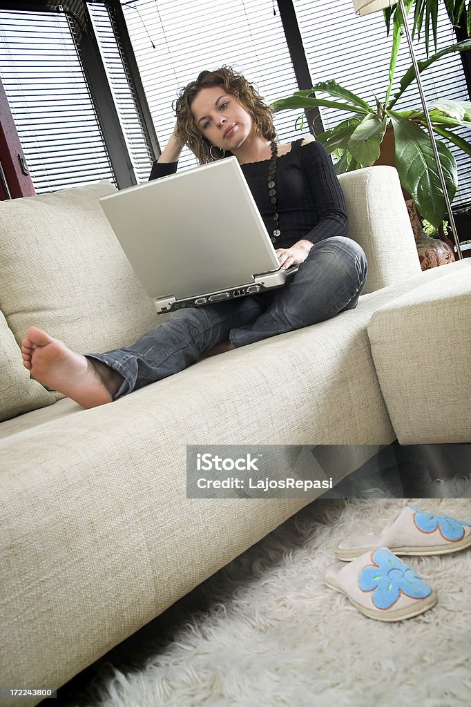 Working at home Beautiful woman using laptop at home. Laptop Stock Photo