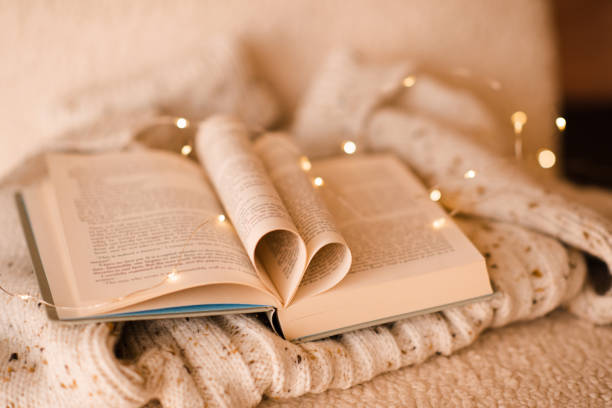 istock Heart shaped paper book over xmas lights 1722439421