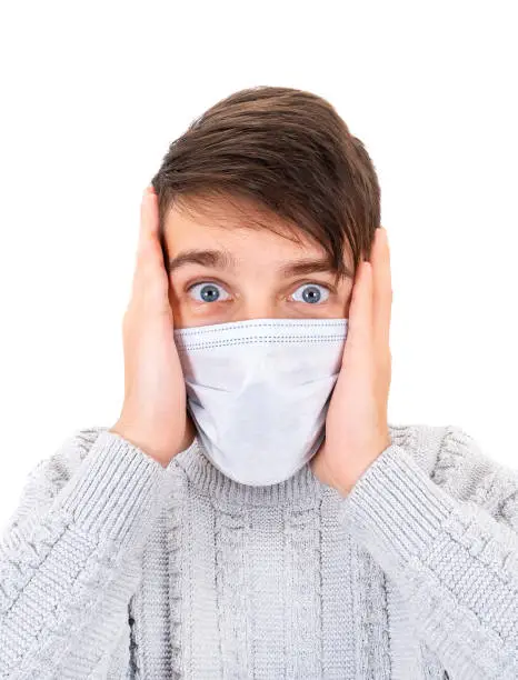 Surprised Young Man in the Surgical Mask Isolated on the White Background closeup