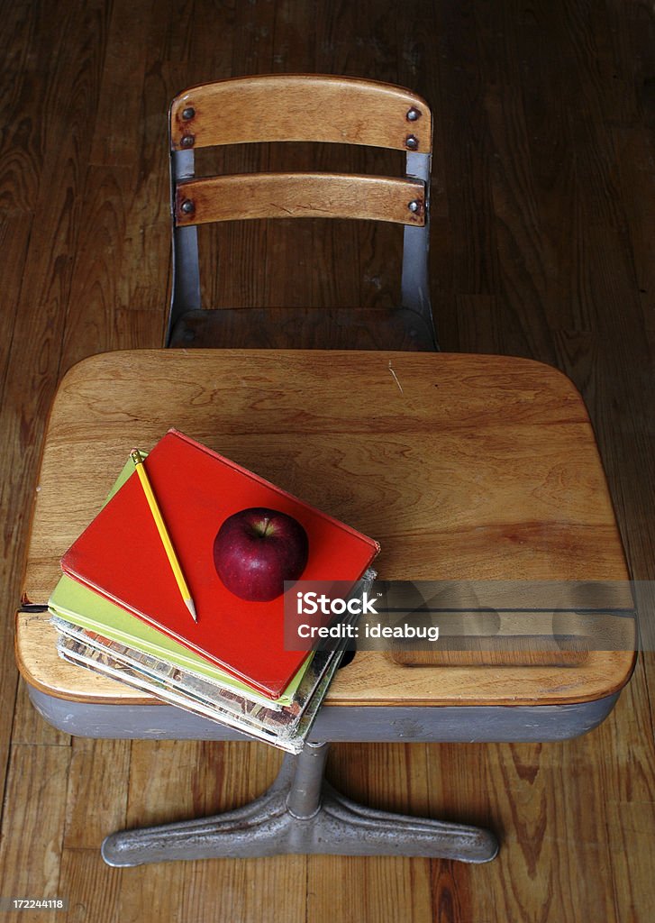 In School "Vintage school desk with a stack of old textbooks, a pencil, and an apple." Antique Stock Photo