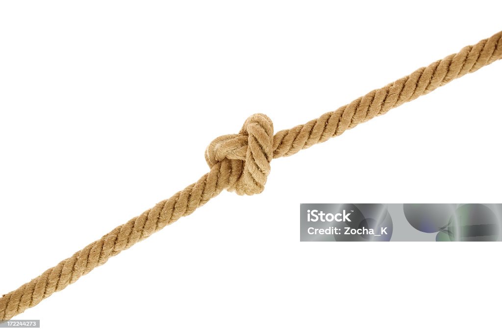 A rope with a knot on a white background Tied knot on rope. Related images: Rope Stock Photo