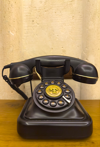 A black vintage rotary dial telephone