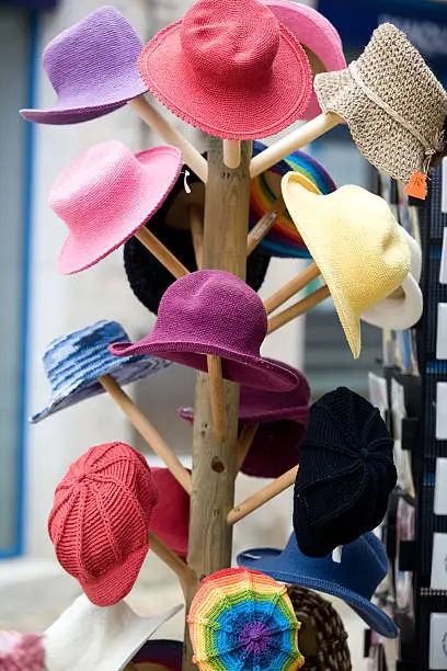 Colourful hats on a wooden rack for sale