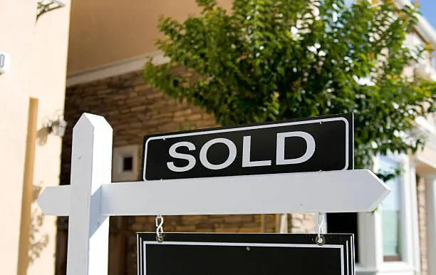 Photo of A real estate sign saying sold