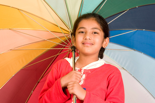 Sweet Indian Girl with a multi colored umbrella