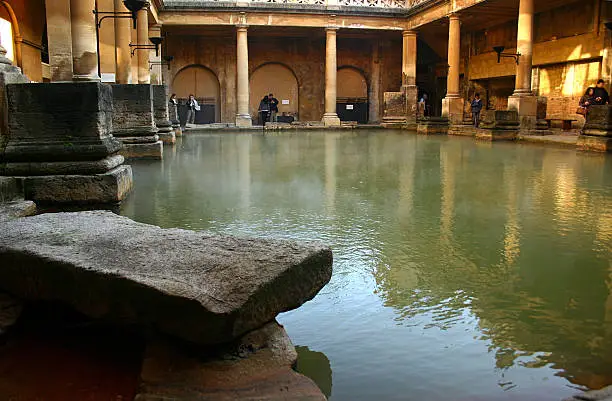 Stone and columns that was built by the Romans for people to enjoy the healing powers of the water, the steamy mineral waters are England’s only naturally occurring hot springs. This Historic Roman Bath is in Bath England UK