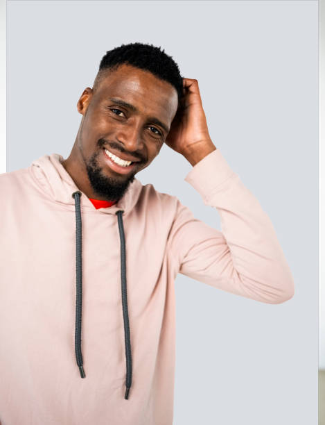 istock Happy young african man with his hand on head and smiling in studio 1722464044